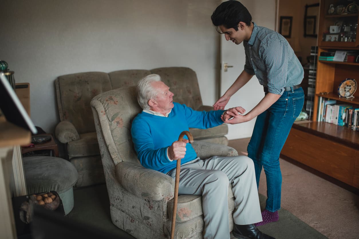 Teenager Helping his Grandfather at Home stock photo